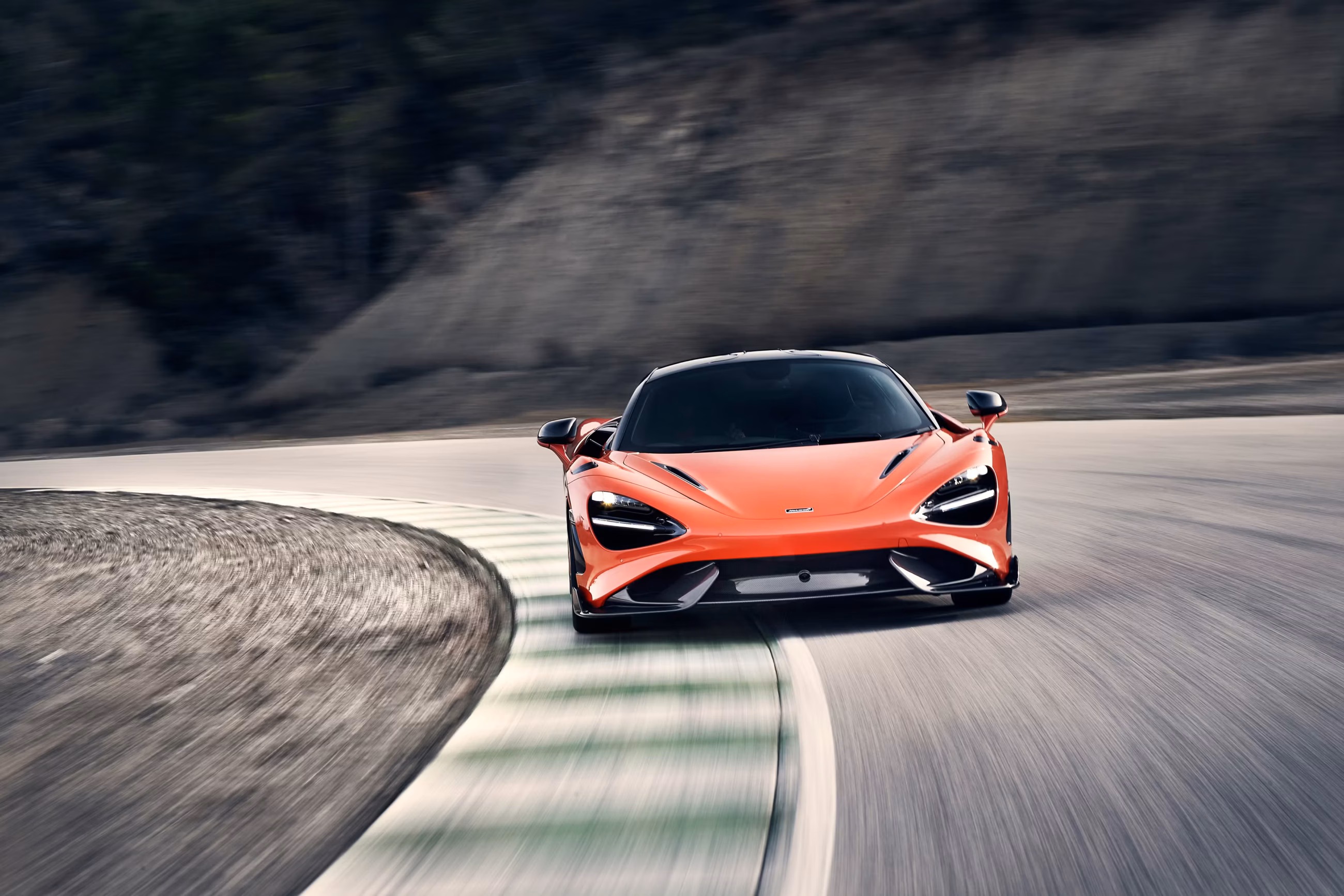 McLaren 765LT coupe with roof scoop on a race circuit